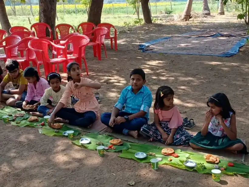 Families sharing the full lunch at long tables