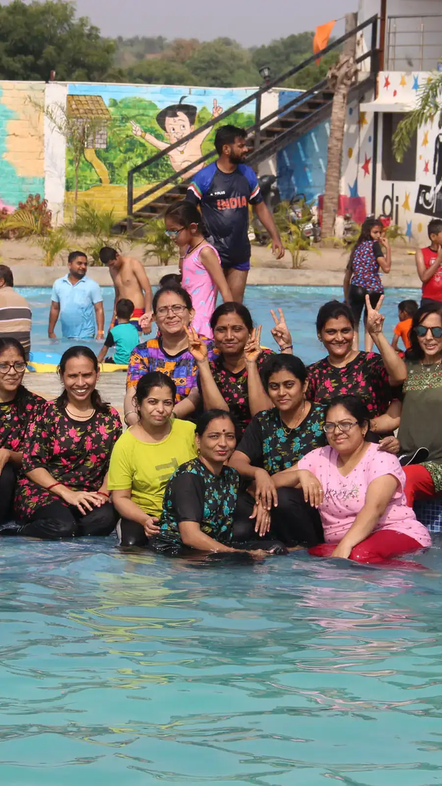 A tall group photo of families crowded together at the park