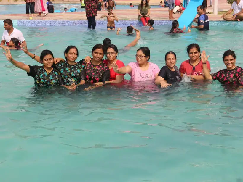 Women from member families laughing together in the pool